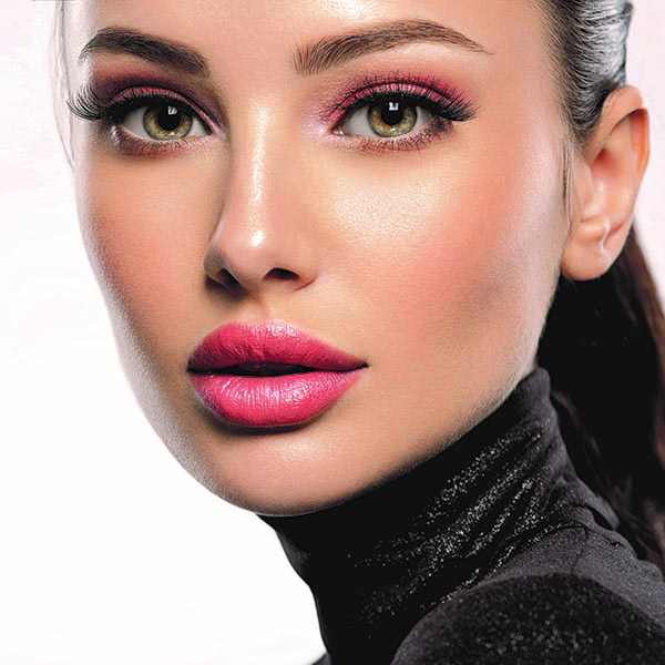 Portrait of beautiful young woman with bright pink makeup. Beaut